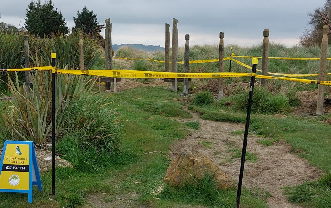 1 Moeraki DOC Moeraki Zooming in on the piles for the visitors hut with the JDBuilders sign on the left and safety tape in the foreground to stop visitors walking through this area JDBuilders