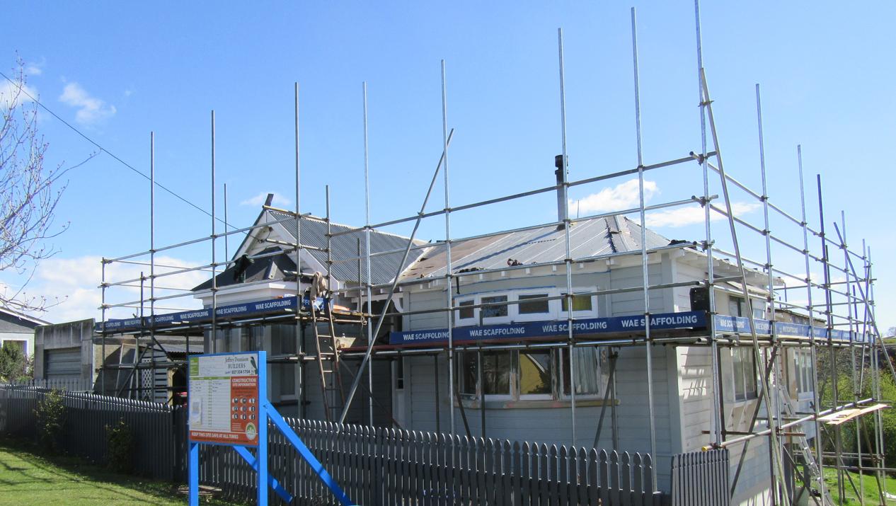 1 Ronaldsay St Palmerston view of the house with the saffolding with roof replacement underway JDBuilders