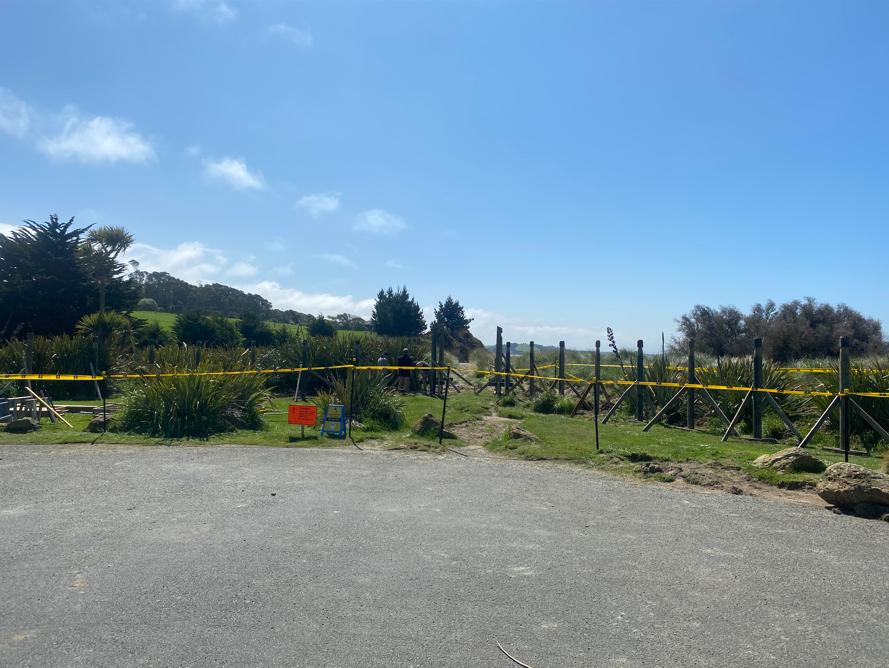 2 Moeraki DOC Moeraki View from the carpark, showing all the piles for the palisades and visitors hut in the background with safety tape in the foreground blocking off this area JDBuilders