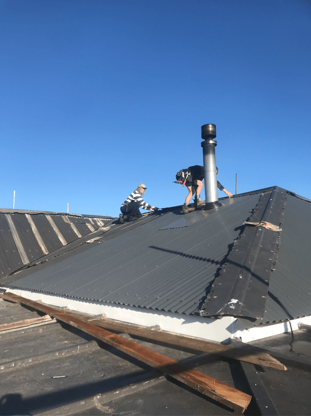 2 Ronaldsay St Palmerston Some of the team putting on ridge capping for the roof