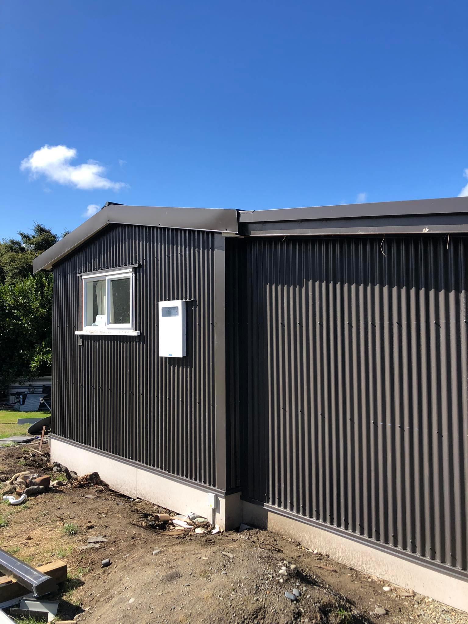 Semple Street Kakanui Renovation using MagnaFlow corrugate as cladding side of house with windows next to power meter JDBuilders 1