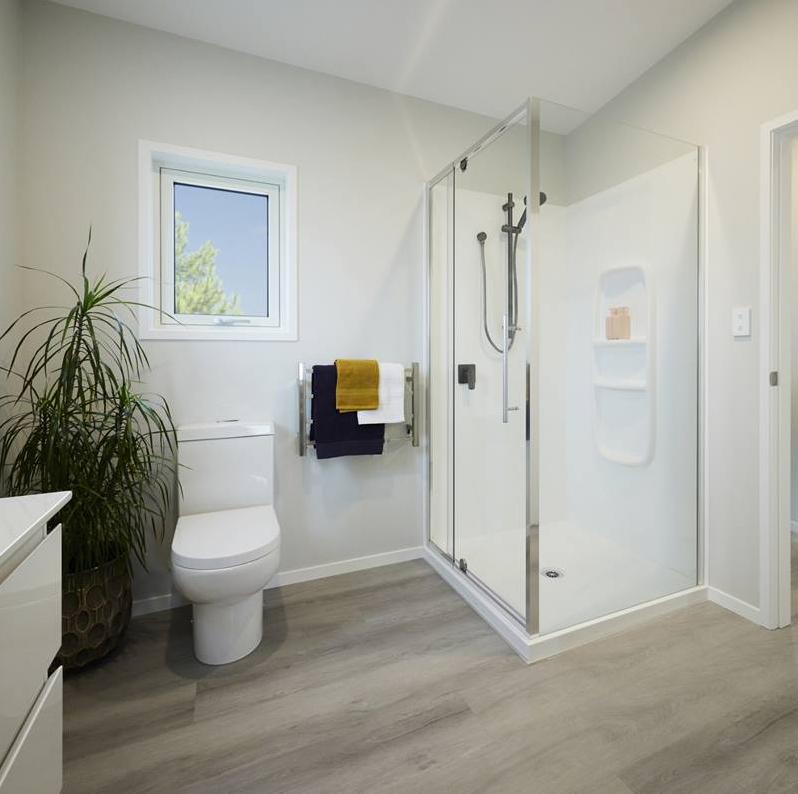 7 Angus Clever Living Homes View of the ensuite bathroom with the shower to the right, vanity on the left and the toilet in the centre background JDBuilders