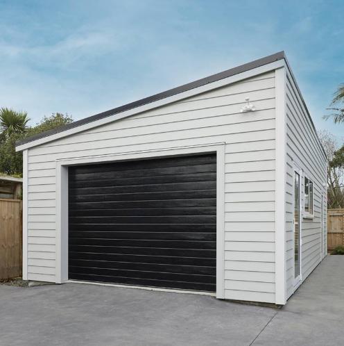 2 Garages Clever Living Homes View of a car garage from the front with the automatic door closed JDBuilders
