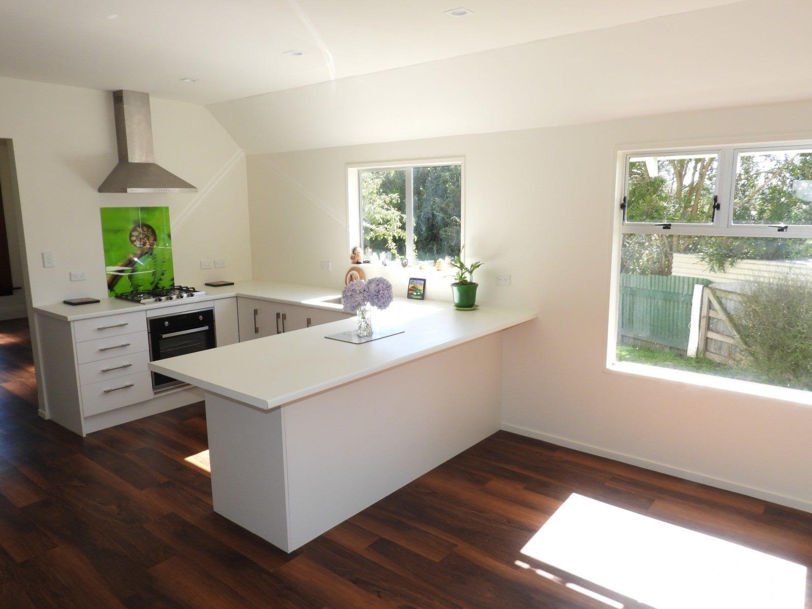 Main 66 Norwich St, Hampden Renovation of kitchen showing new stove, rangehood and, benchtops JDBuilders