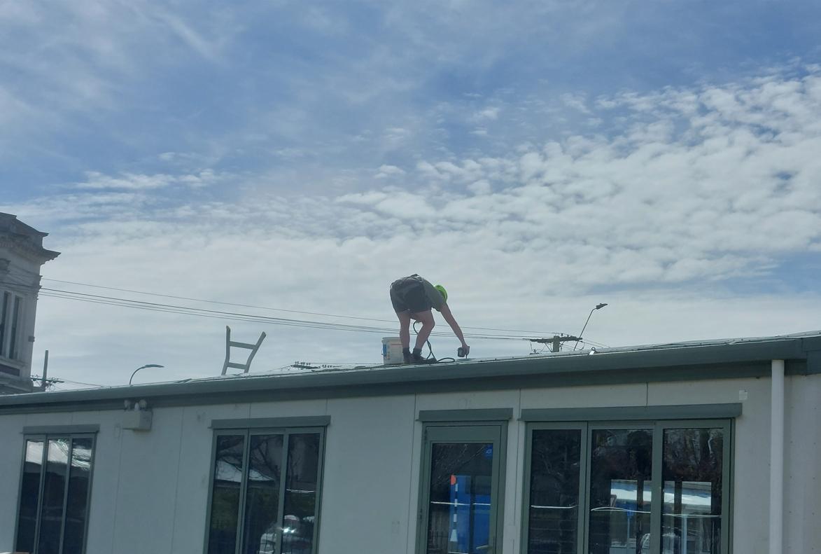 35 Fenwick Primary School, Oamaru Removal of the ridge caps on the roof from one of the learning spaces by one of our staff JDBuilders